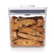 An OXO Good Grips square food storage container filled with cookies with chocolate chips.