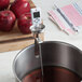 A CDN digital candy thermometer in a pot of liquid.