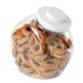 A clear OXO Good Grips plastic food storage container filled with pretzels.