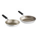 Two Vollrath Wear-Ever aluminum non-stick frying pans with black silicone handles.