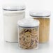 An OXO Good Grips clear plastic food storage container filled with cookies.