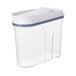 A clear OXO food storage container with a white lid.