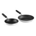 Two Vollrath aluminum frying pans with black silicone handles.