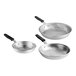 A group of silver Vollrath Wear-Ever frying pans with black silicone handles.