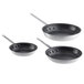 A group of three Vollrath Arkadia aluminum non-stick frying pans with lids.