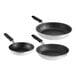 Three close-up Vollrath Wear-Ever aluminum frying pans with black handles.