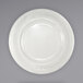 An International Tableware ivory stoneware plate with a rolled edge and decorative pattern.