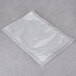 A clear plastic ARY VacMaster vacuum packaging bag on a grey surface.