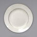An International Tableware ivory stoneware plate with a gold rim.