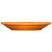 An orange International Tableware Cancun stoneware saucer on a white background.