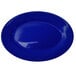 A cobalt blue stoneware platter with white lines on the rim.