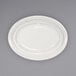 An ivory stoneware platter with a wide rim and an embossed pattern.