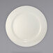 An International Tableware stoneware plate with a white circular edge on a gray background.