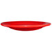 A crimson red stoneware plate with a rolled edge on a white background.