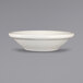 An International Tableware Roma stoneware fruit bowl in ivory on a gray surface.