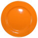 An orange International Tableware Cancun stoneware plate with a wide rim and rolled edge.