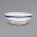 A close up of a white International Tableware stoneware bowl with blue lines.