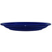 A cobalt blue International Tableware stoneware plate with a white spot.