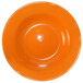 A close-up of an orange International Tableware stoneware bowl.