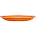 An orange International Tableware narrow rim platter on a white background.