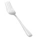 A silver Vollrath Queen Anne serving fork with a white handle.
