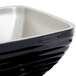 A black and silver Vollrath serving bowl with a beehive pattern on the counter.