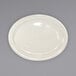 An International Tableware Valencia ivory stoneware platter with a narrow rim on a gray surface.