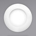 A bright white porcelain pasta bowl with a textured rim.