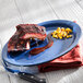 An International Tableware ocean blue narrow rim stoneware platter with ribs and corn on it.