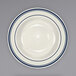 An ivory stoneware deep rim soup bowl with blue bands on it.
