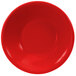 A close-up of a red bowl with a white background.