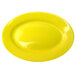 A yellow stoneware platter with a wide rim.