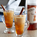 Two glasses of hot coffee with DaVinci Gourmet Cinnamon Bark syrup and cinnamon sticks.