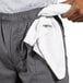 A person with a towel in their pocket wearing Uncommon Chef slate gray cargo chef pants.