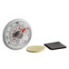 A Comark UTL140 stick-on thermometer on white counter next to a coin.