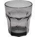 A clear plastic tumbler with a faceted rim and a black rim.