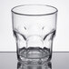 A Carlisle clear plastic tumbler with a curved rim.