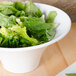 An American Metalcraft flared round melamine bowl filled with lettuce and other food.