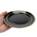 A hand holding a Fineline Silver Splendor black plastic plate with gold bands.