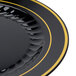A close-up of a Fineline black plastic plate with a gold border.