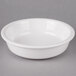 A Fiesta white china bowl on a gray surface.
