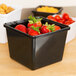 A black square melamine crock with strawberries in it.