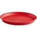A red round plastic serving tray with a white background.