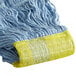 A Carlisle blue cotton blend mop head with a yellow headband.
