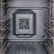 A close up of a fan inside a black Cambro food holding cabinet.