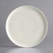 A white Luzerne porcelain coupe plate with a gray speckled rim.