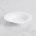 A Sant'Andrea Francia bright white porcelain bowl with an embossed pattern on a white surface.