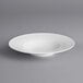 An Acopa Liana bright white porcelain pasta bowl with embossed lines on the rim.