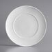 A white Acopa porcelain plate with an embossed circular pattern on the rim.