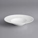An Acopa Liana bright white porcelain pasta bowl with embossed lines on a white background.